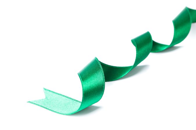 Green ribbon isolated on plain background. Gift concept