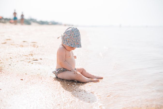 Cute baby sitting on beach