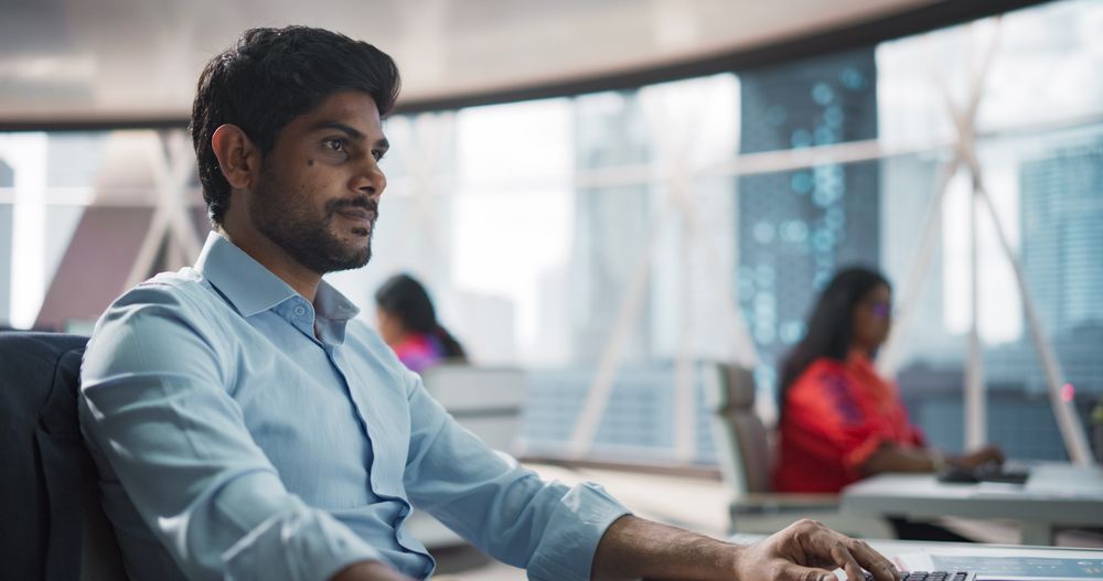 Close-Up of a Young Indian Male Professional Working in a Business Research and Development Company.