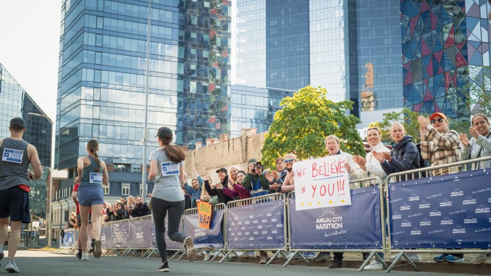 Back View: Diverse Group of Marathon Joggers Competing for the First Place, Running in a City Trail