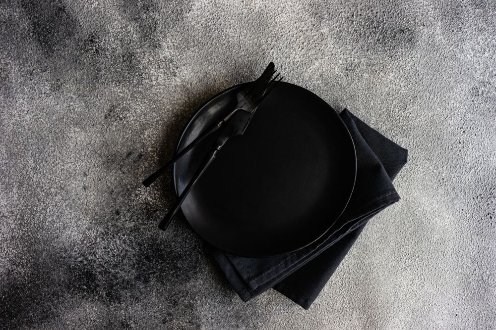 Top view of table setting with elegant grey plate with copy space