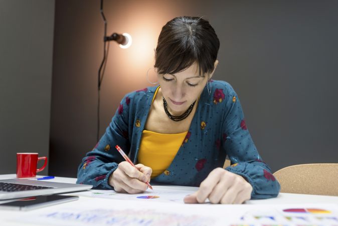 Woman working with charts in office