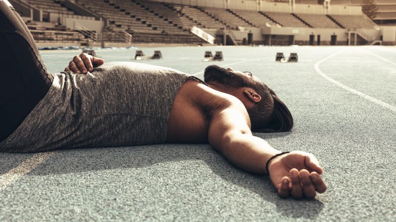 Close up of a tired athlete relaxing after a run