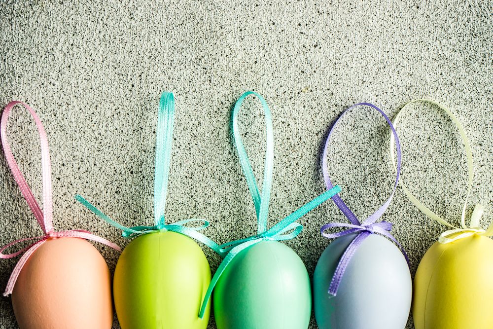 Easter card concept with line of pastel egg ornaments