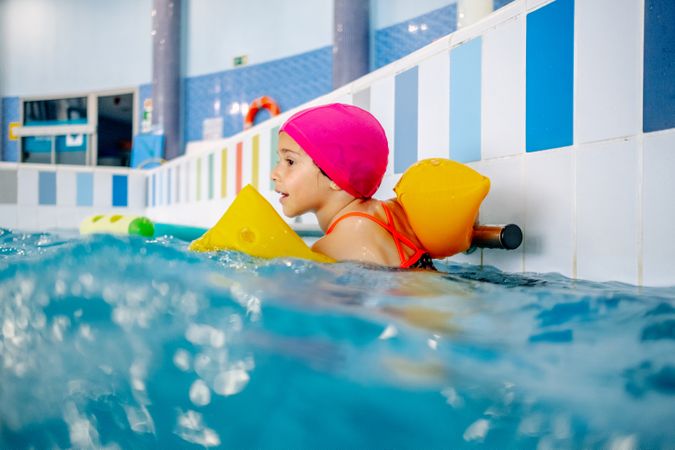 girl with water wings in swimming pool