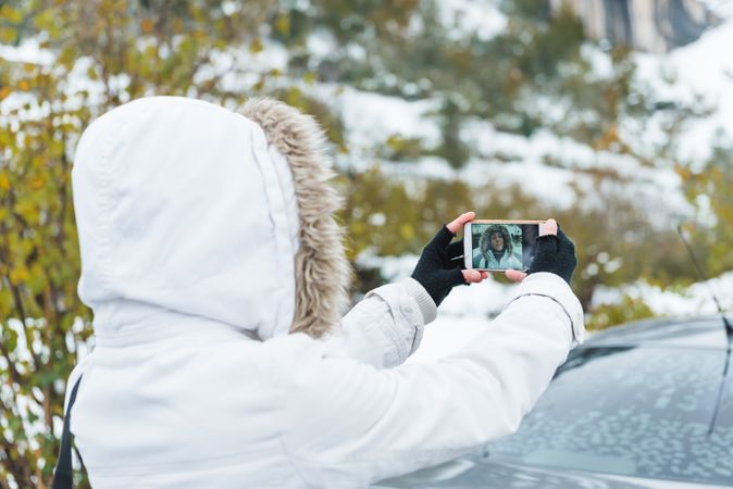 Woman taking selfie on nature at winter