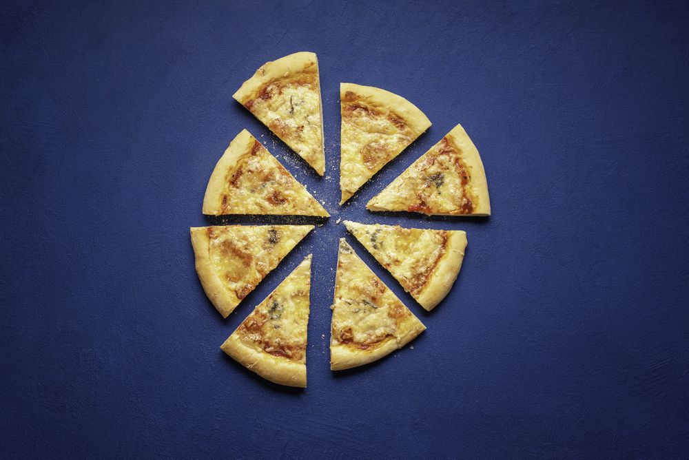 4 cheese pizza slices on velvet background