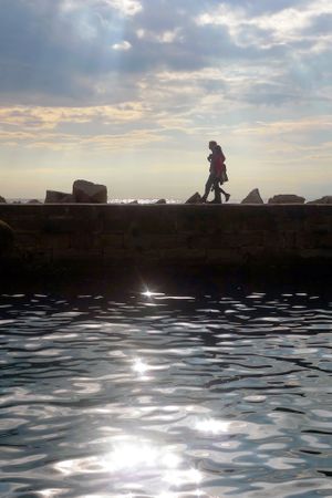 Couple walking along a pier