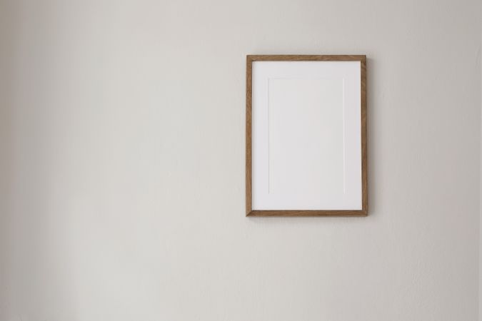 Mock up framed poster on blank wall