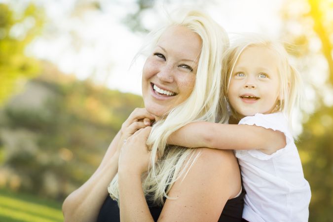 Mother and Little Girl Having Fun Together in Grass