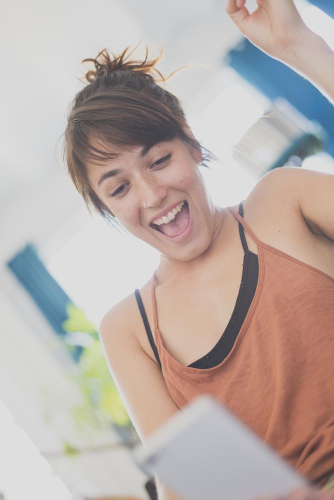 Joyful woman reading something on phone