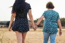 Two Generations Of Women Hold Hands: Grandmother And Granddaughter Holding Hands