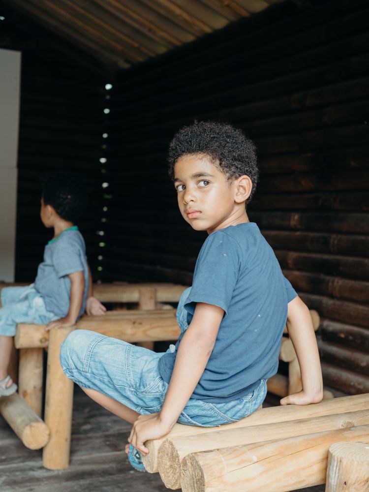 Black boy inside wooden house