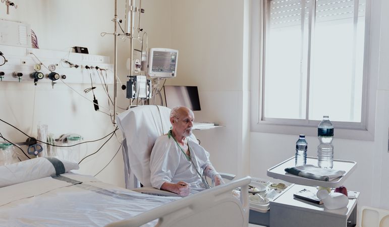 Older man admitted to a hospital room.
