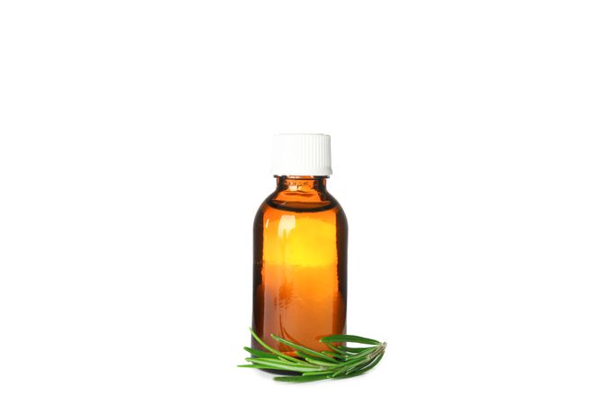 Rosemary oil in jar isolated on neutral background
