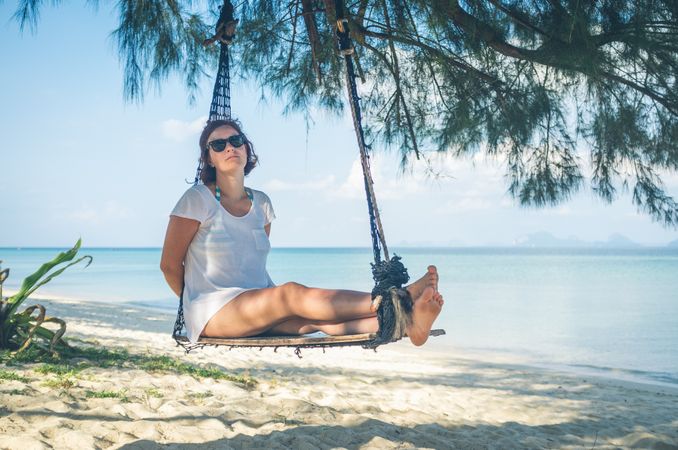 Woman in hammock near sea