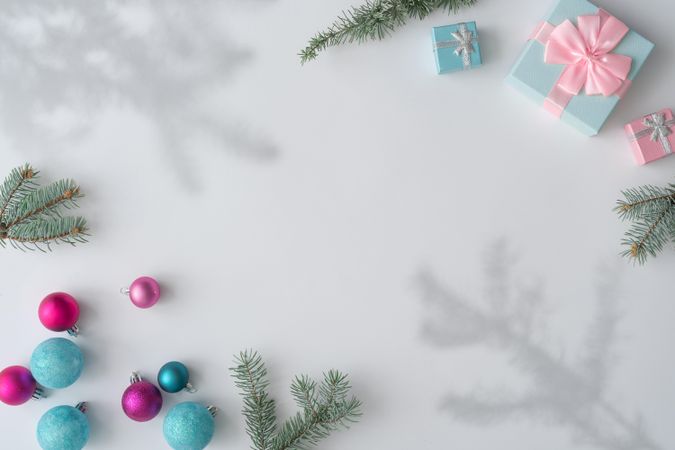 Christmas decorations, gifts with branches, and shadows on corners of light background