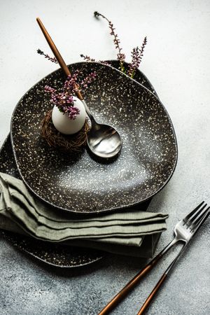 Easter table with heather and egg decor on dark plate