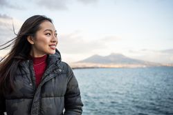 Woman on vacation in warm wear on seashore
