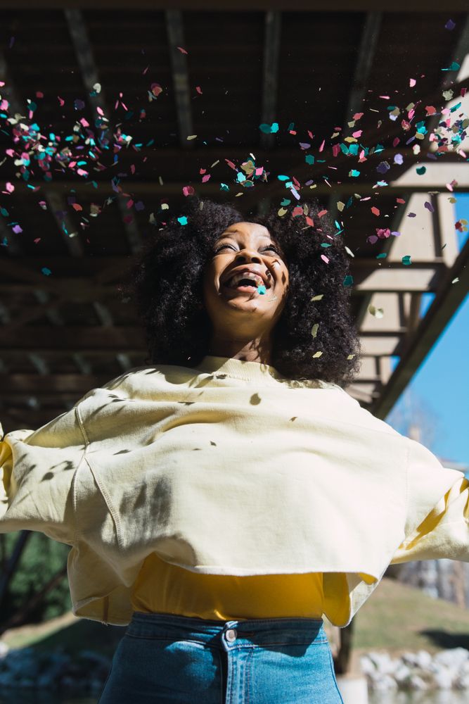 Woman throwing confetti in the air.