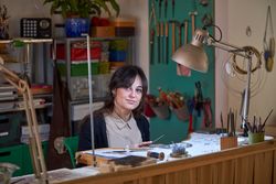 Charming woman working in creative workshop