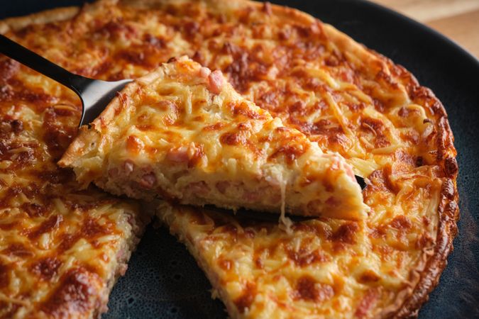 Cheese and bacon quiche on plate