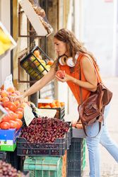 Woman choosing fruit in an ecological fruit shop