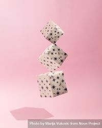 Three gift wrapped Christmas presents suspended on soft pink background with shadow 5pdq85