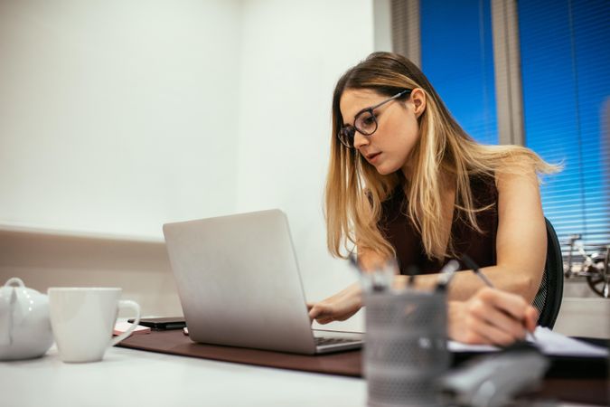 Woman entrepreneur sitting at office working