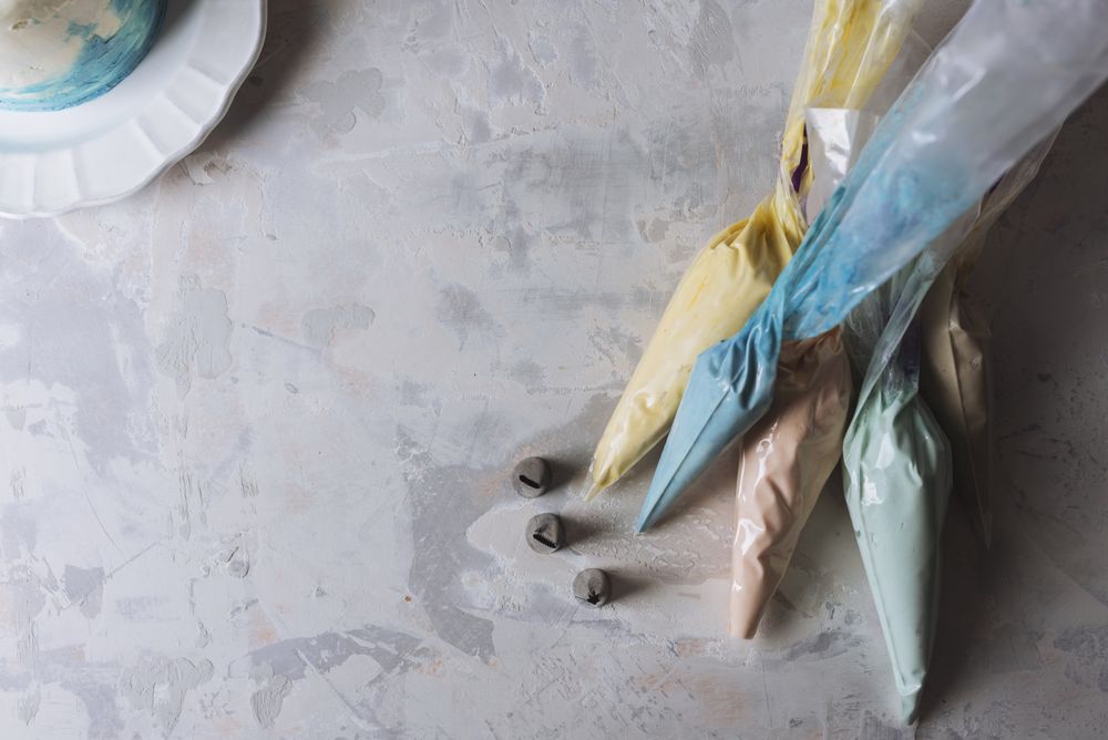 Cake decoration -pastry bags filled with full frosting color, and stainless pipping nozzles,