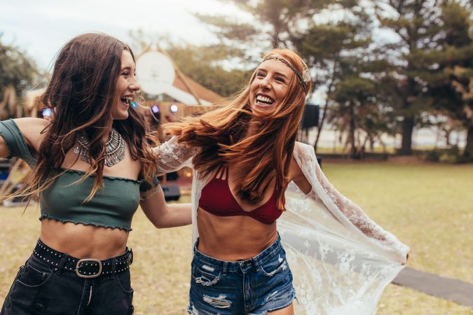 Girlfriends in summer wear enjoying at music festival
