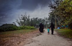 Women walking with daughter in a park