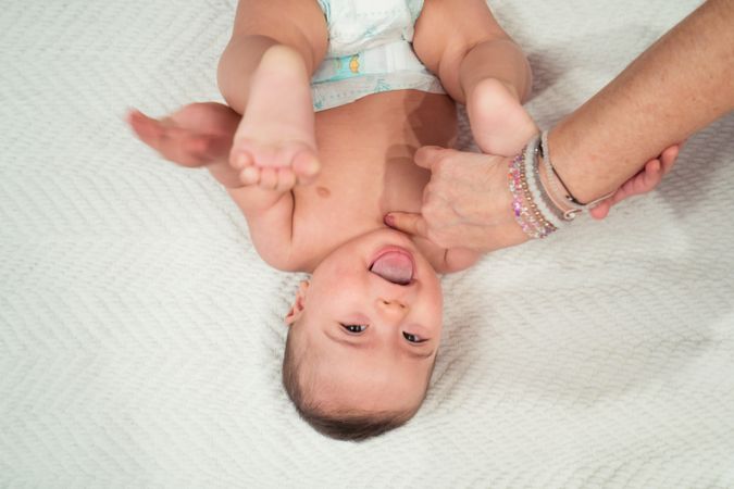 Portrait of cute baby boy with Down syndrome and his mother