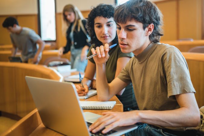 Students analyzing data on laptop during lesson