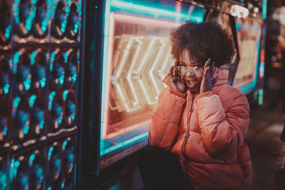 Black woman standing on night city street