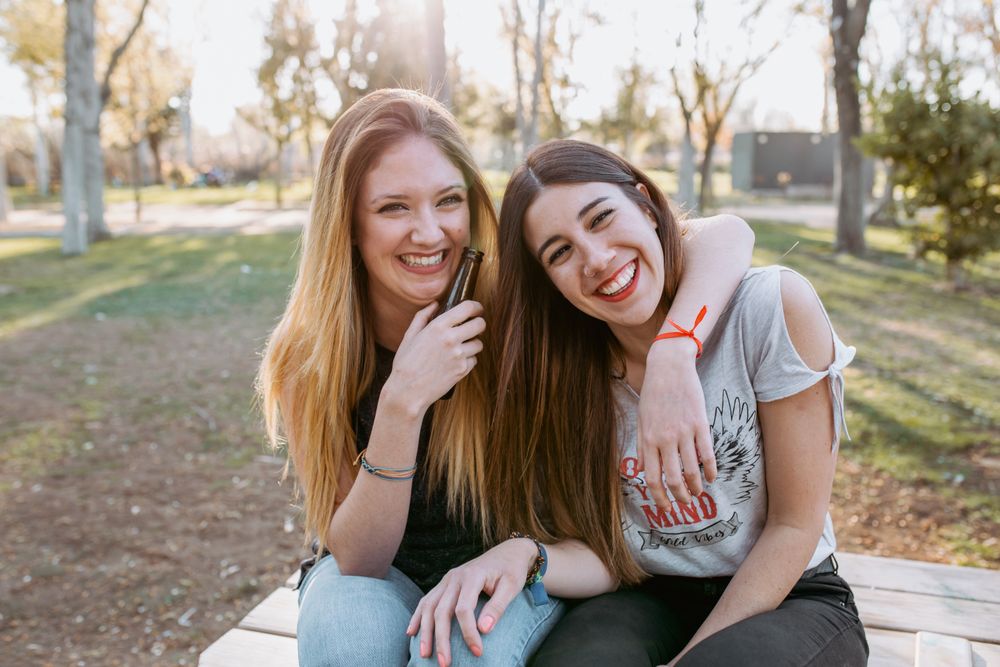 Woman hugging and laughing in park