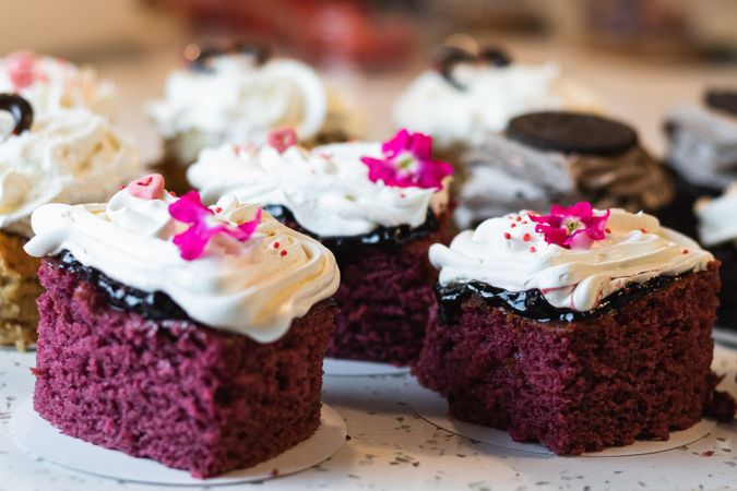 Sweet sponge cakes with whipped cream in bakery