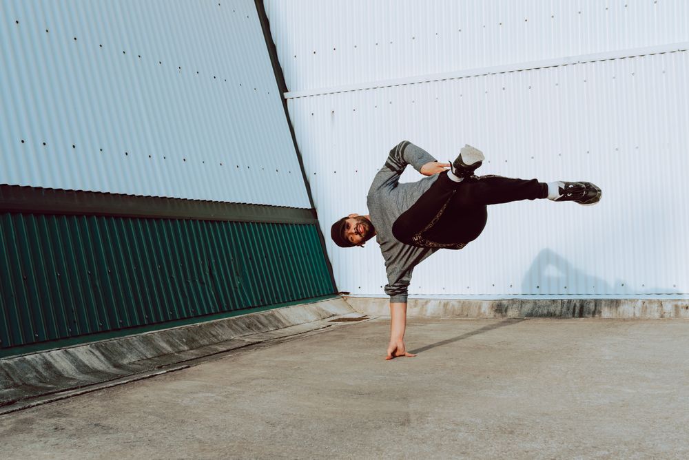 Man performing handstand near wall