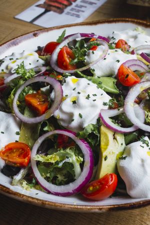 Vegetables salad with onion greens and cream sauce
