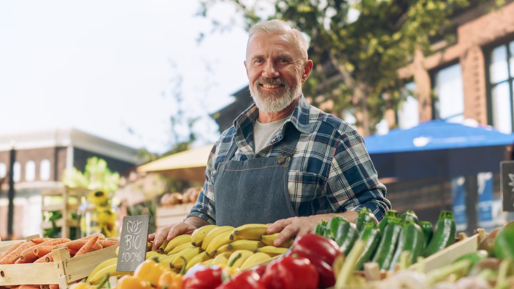 Portrait of a Man Managing a Street Vendor Food Stand with Fresh Natural Agricultural Products.
