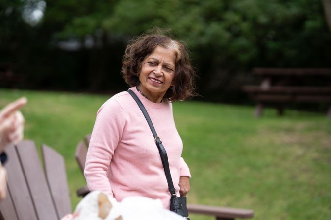 Indian woman sitting outside in park