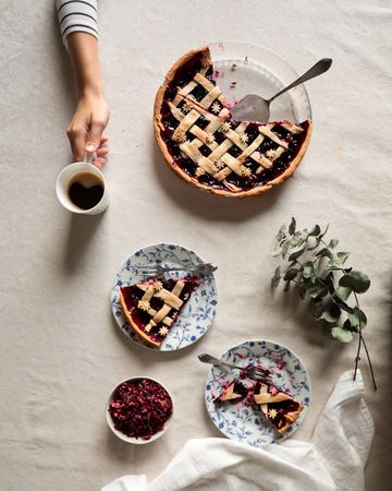 Faceless person enjoying coffee with homemade pie