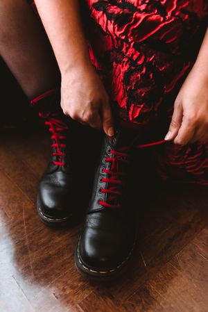 Woman in dress lacing boots