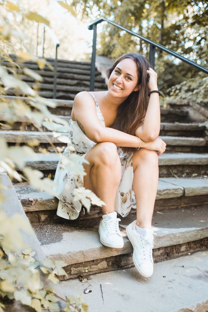 stylish woman sitting on stairs of park in New York