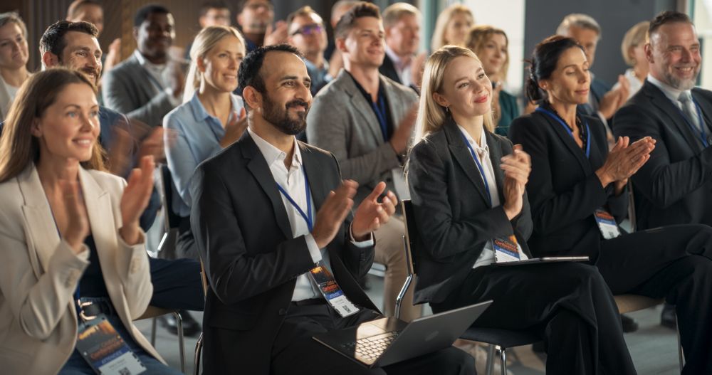 Crowd of Smart Tech People Applauding in Conference Hall During a Motivational Keynote Presentation By Innovative Company.