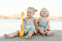 Happy kids playing with toy on beach