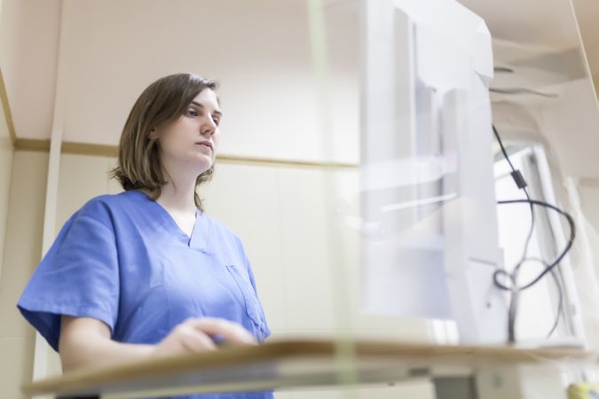 Female doctor using digital equipment for mammography