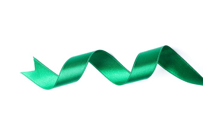 Green ribbon isolated on plain background. Gift concept