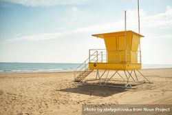 Yellow lifeguard station on an empty beach 0v8Ko4
