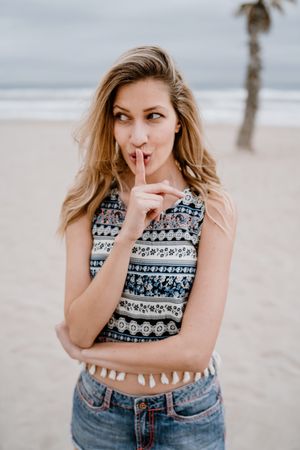 Happy female posing on sandy beach